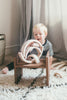 Little boy playing with wood stacking toy
